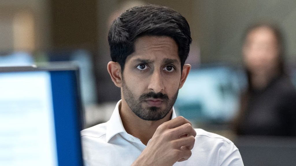 Rishi looks intently from behind a computer screen in Industry