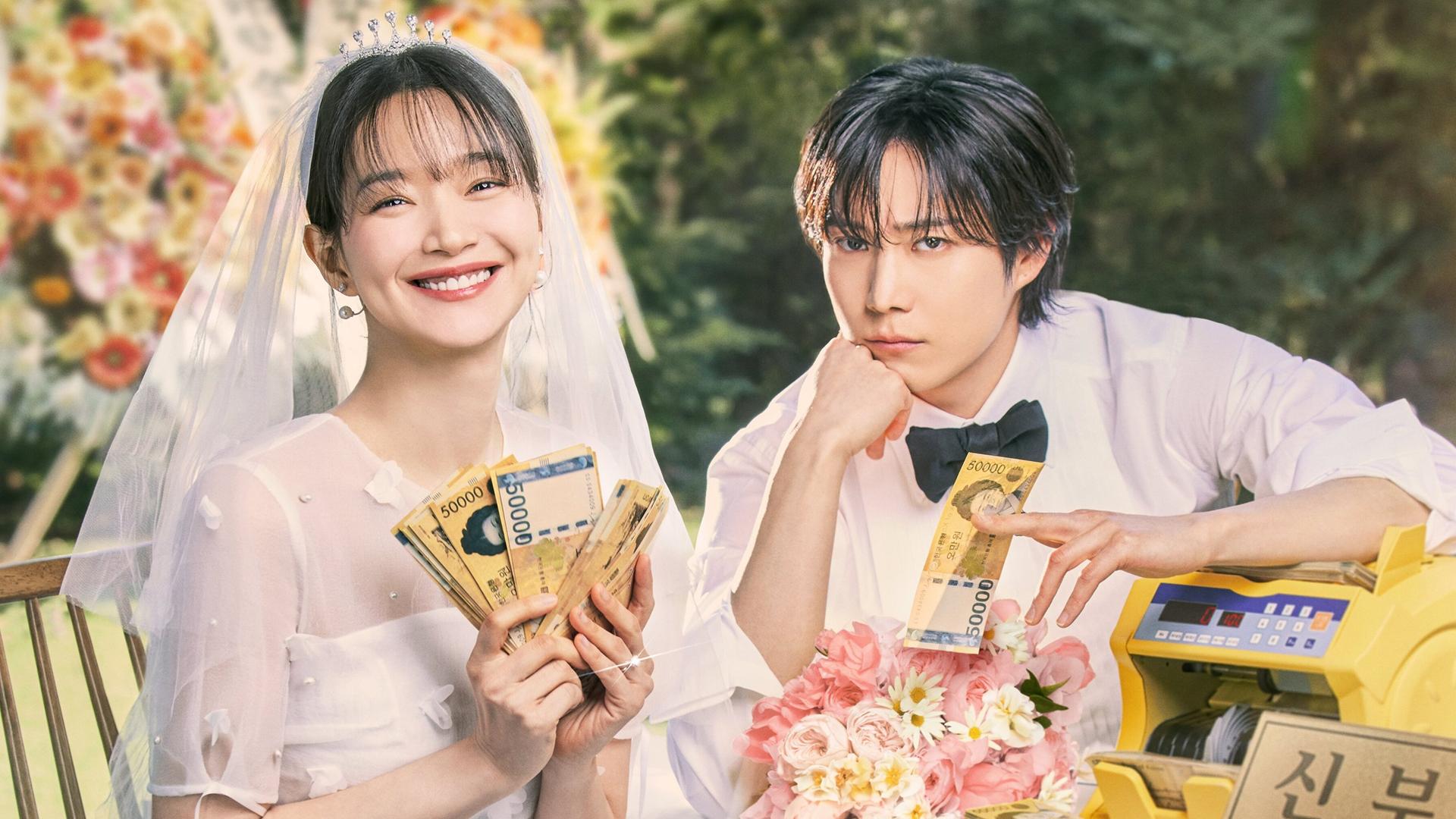 Hae-yeong and Ji-wook hold money at their wedding