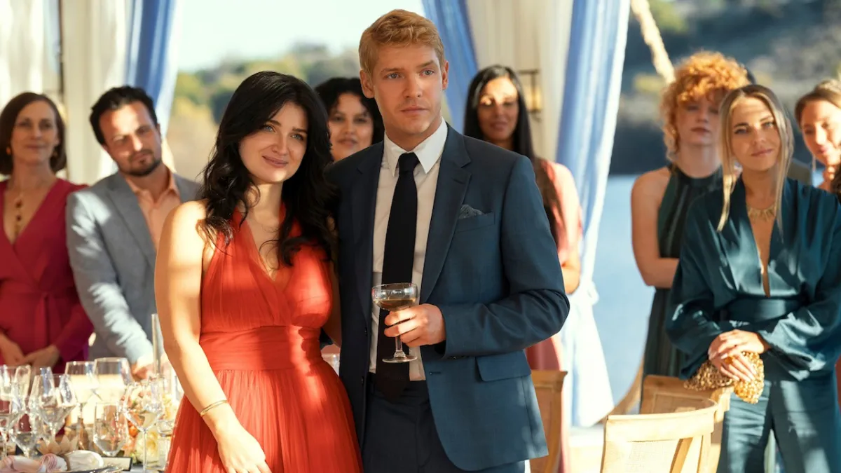 Amelia and her fiancee, standing in front of guests, in The Perfect Couple.