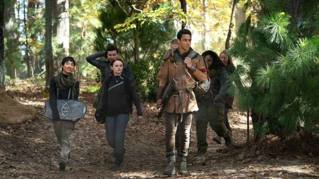 The cast of Netflix's Uglies, walking through a forest.