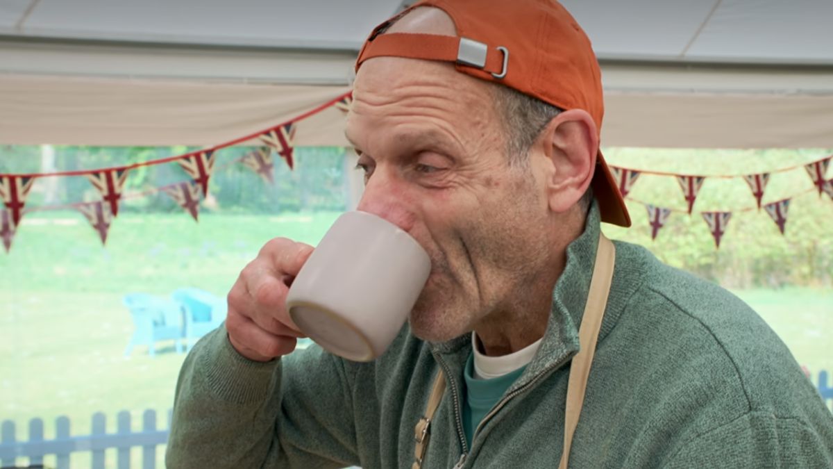 Jeff on Great British Bake Off, sipping a mug of tea