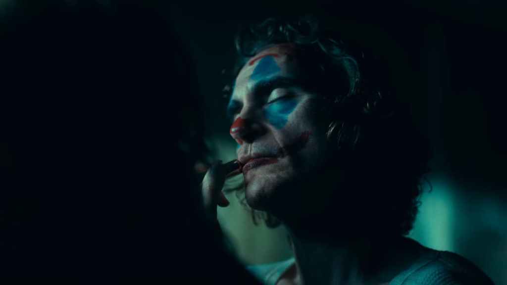 Harley (Lady Gaga) putting makeup on Arthur (Joaquin Phoneix) in Joker: Folie à Deux