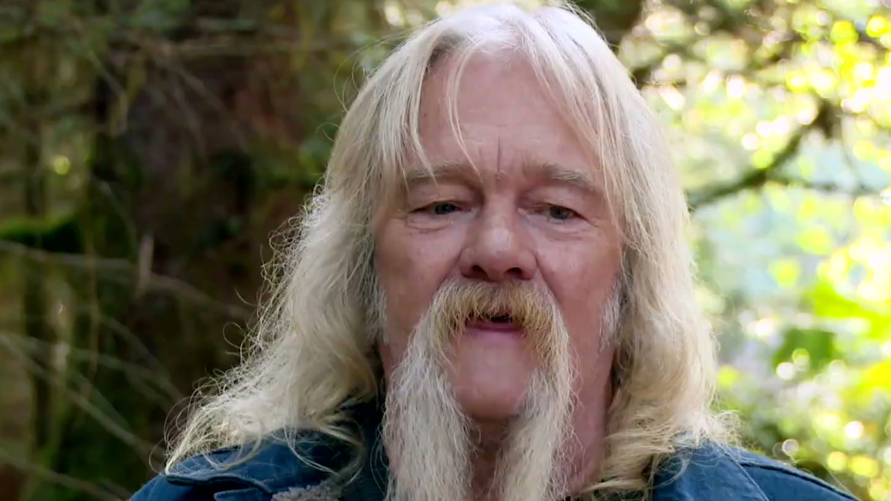 Billy Brown in, a white-haired man with a walrus moustache.