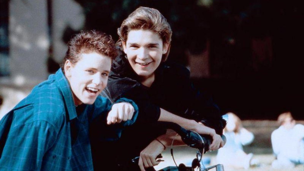 Corey Haim and Corey Feldman, leaning on a motorbike as part of an article about '80s movie stars.