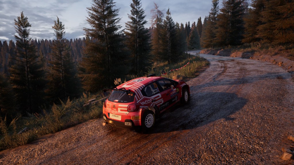 A car drives down a muddy road in the forest