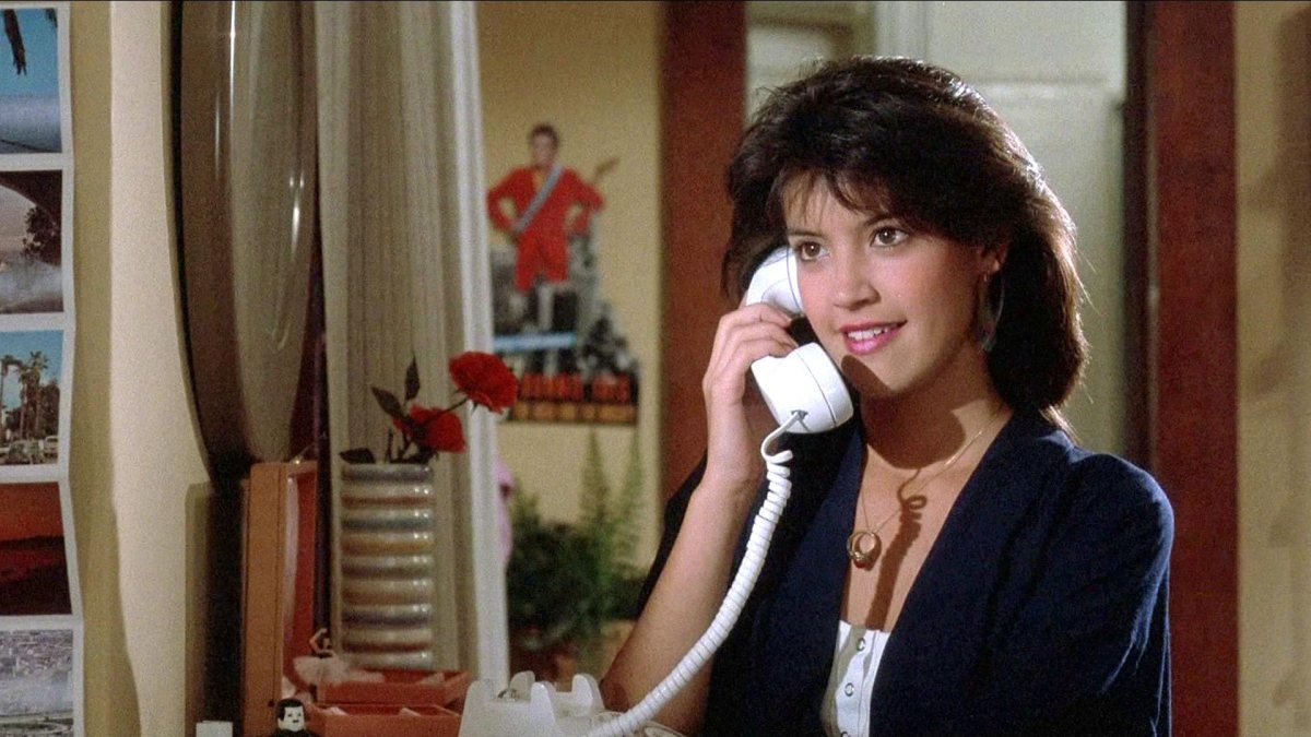 Actor Phoebe Cates, answering a phone in a movie as part of an article about '80s movie stars.