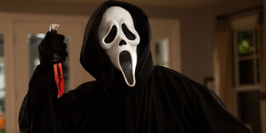 Ghostface holds up a bloody knife  as part of an article about the best horror movies on streaming.