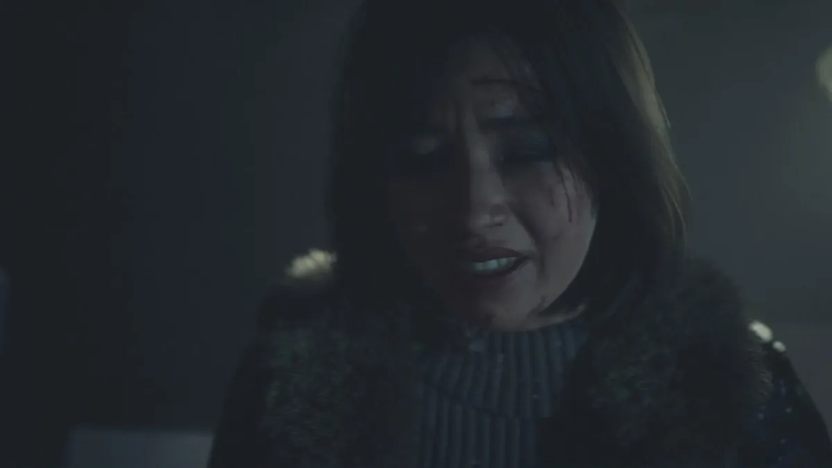 Ashley in the Until Dawn remake, with blood on her face, looking worried. 