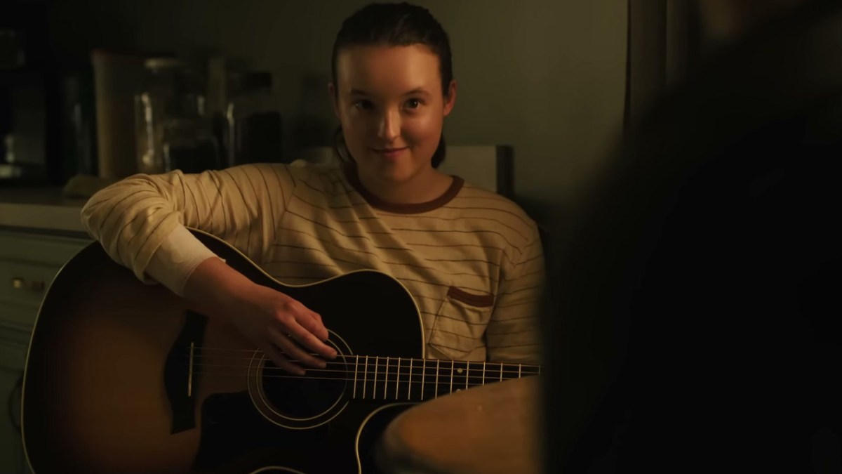 Ellie playing a guitar in The Last Of Us Season 2. 