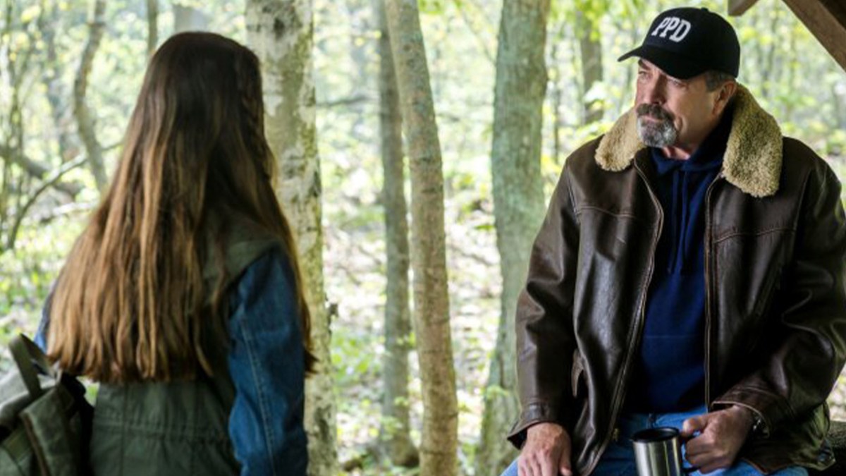 Jesse Stone speaks with a woman in the woods