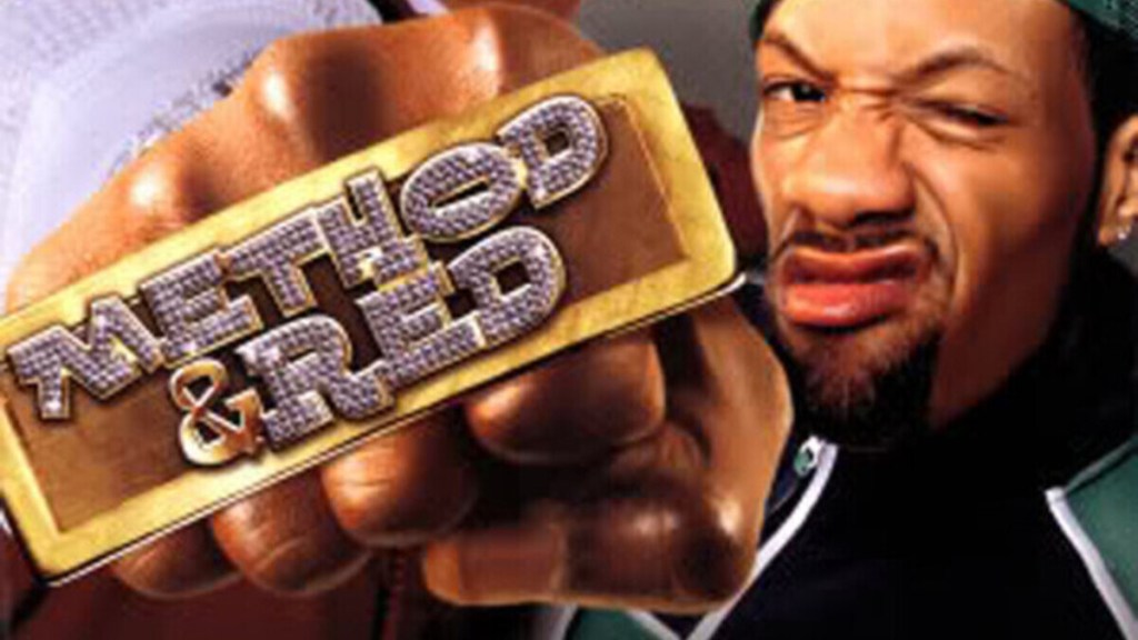 Redman smirks by the Method & Red logo