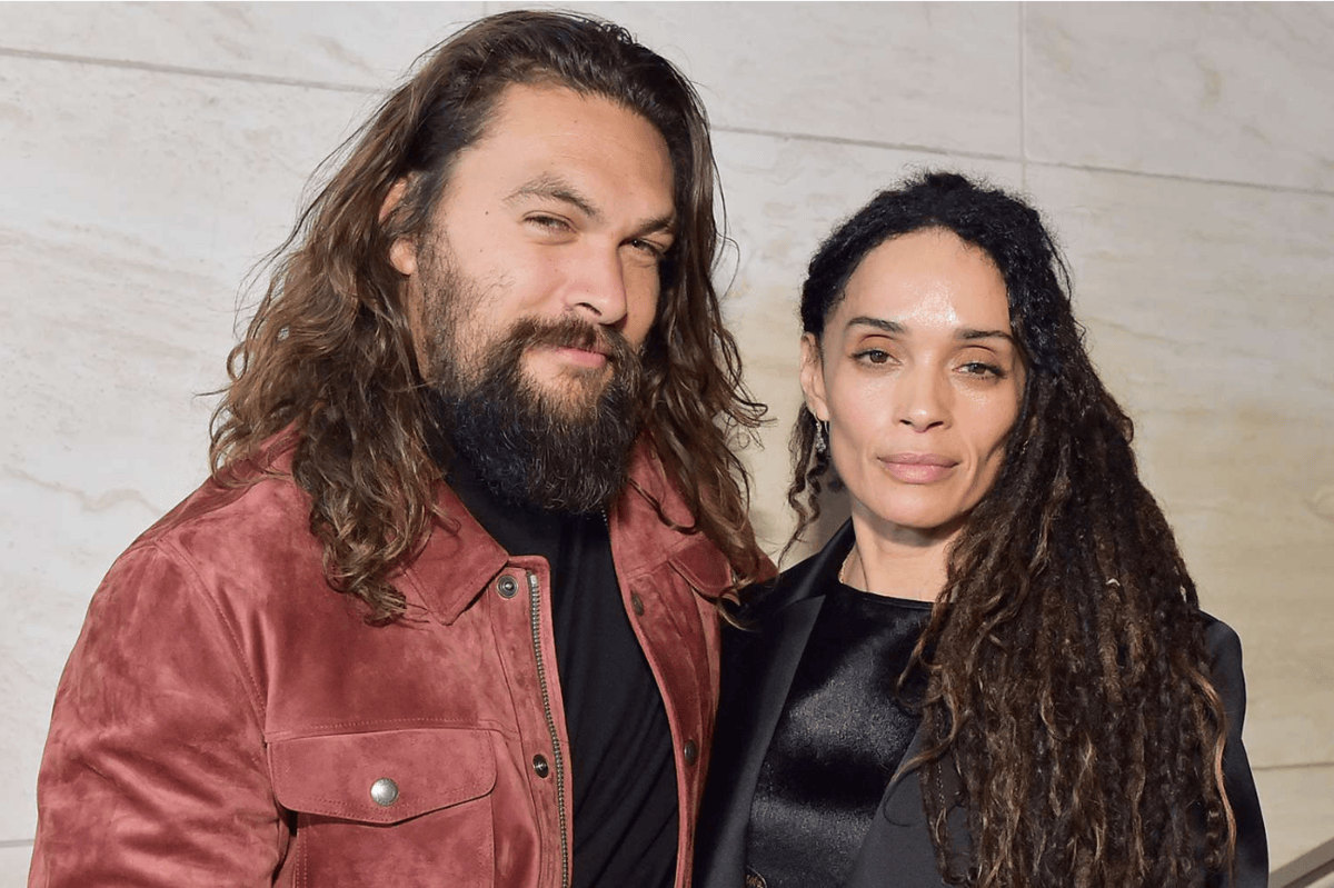 Jason Momoa and Lisa Bonet smiling together as part of an article about celebrity divorces.