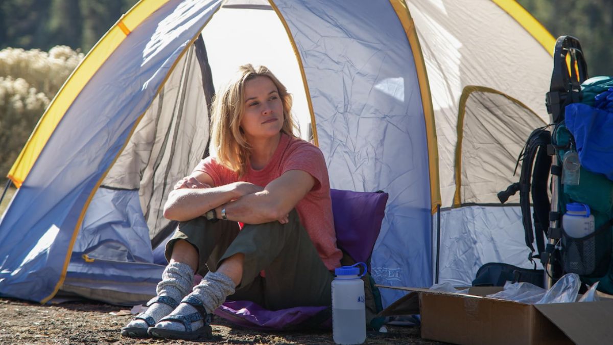 Reese Witherspoon sitting by a tent as Cheryl Strayed in Wild