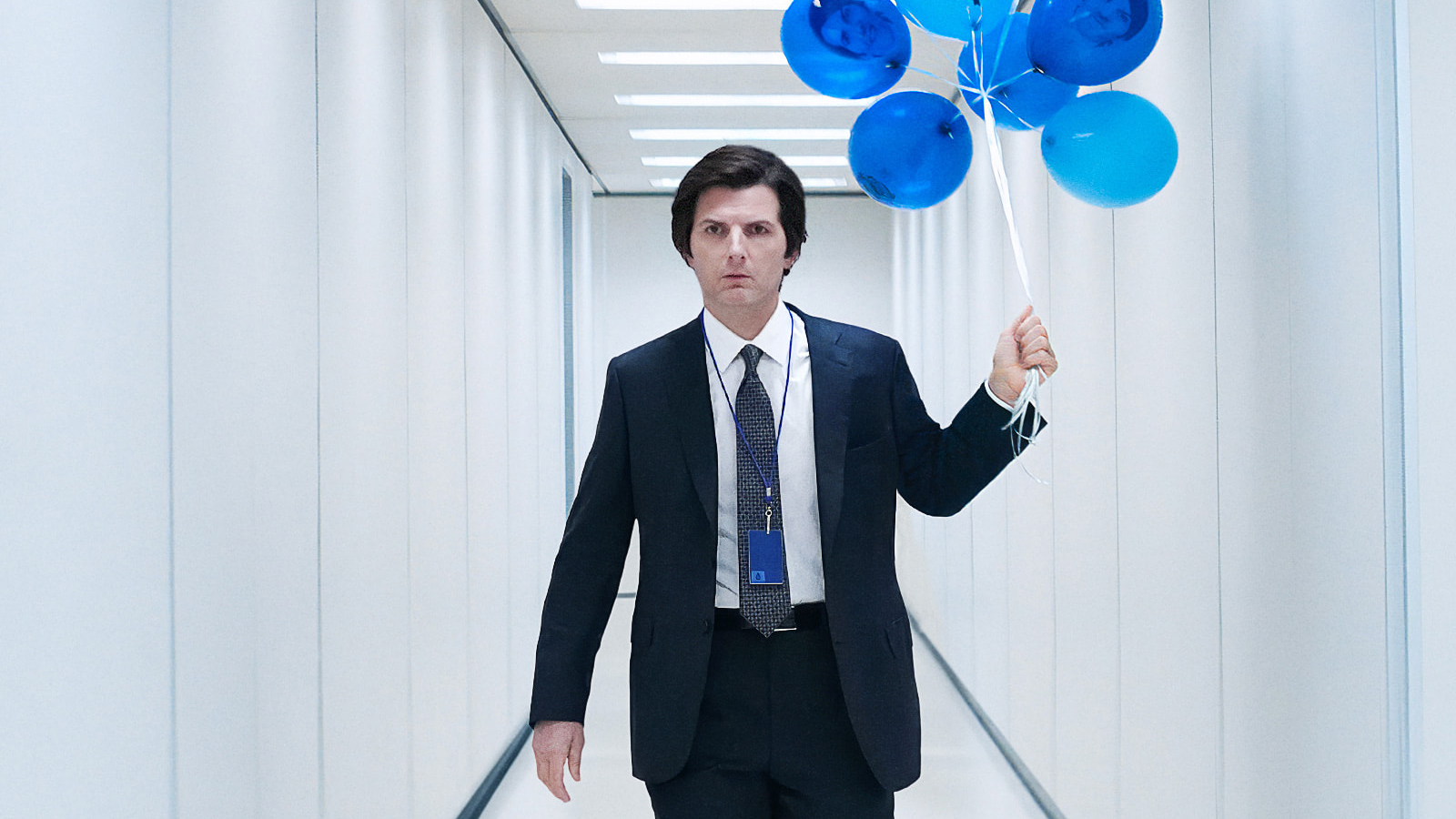 Mark Scout holding a bunch of blue balloons in Severance Season 2