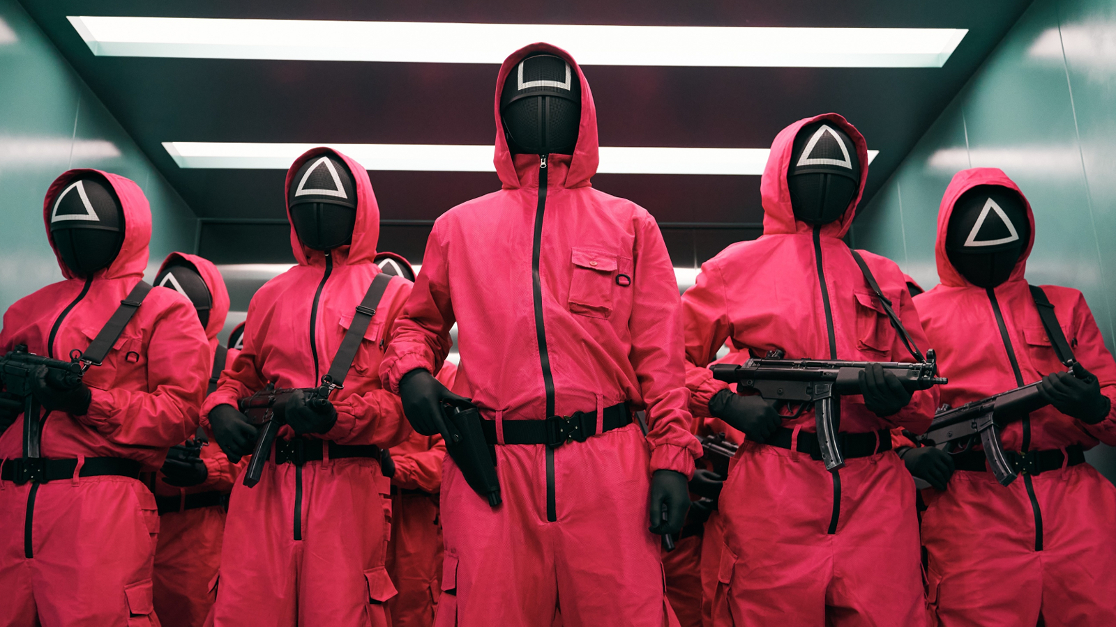 Guards in pink jumpsuits holding guns in Netflix's Squid Game