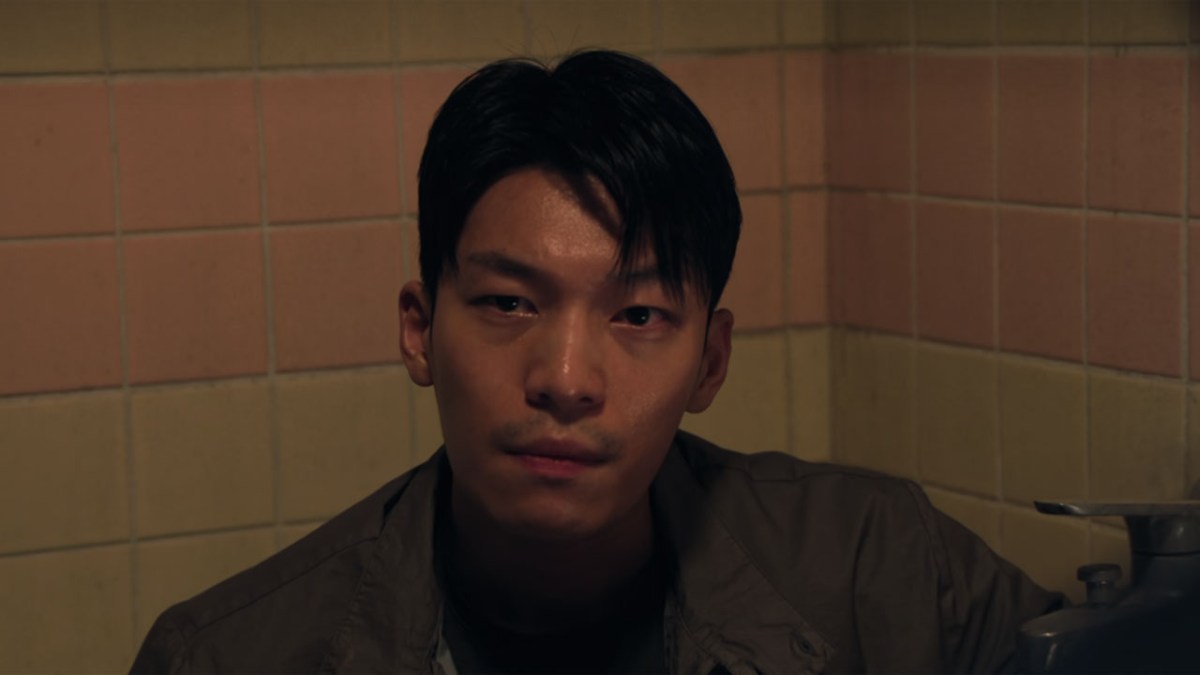 Hwang Jun-ho, a cop in Squid Game, in a bathroom. 